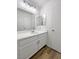 A bright bathroom features a spacious vanity with modern fixtures and wood-style flooring at 2125 Stone Well Rd, North Las Vegas, NV 89031