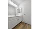 A bright bathroom features a spacious vanity with modern fixtures and wood-style flooring at 2125 Stone Well Rd, North Las Vegas, NV 89031