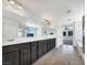 Bright bathroom featuring double sinks, large mirrors, and dark cabinetry, offering a stylish and functional space at 2125 Stone Well Rd, North Las Vegas, NV 89031