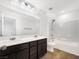 Bathroom features dual sinks, tile flooring, and shower over tub at 2125 Stone Well Rd, North Las Vegas, NV 89031