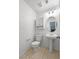 This bathroom features a pedestal sink, vanity lighting, and a tile floor at 2125 Stone Well Rd, North Las Vegas, NV 89031