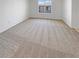 Neutral bedroom with plush carpeting and a large window offering plenty of natural light at 2125 Stone Well Rd, North Las Vegas, NV 89031