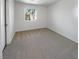 The empty bedroom features neutral carpeting and a window view to the outside at 2125 Stone Well Rd, North Las Vegas, NV 89031