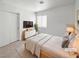 Cozy bedroom with a queen bed, neutral tones, and sliding door closet at 2125 Stone Well Rd, North Las Vegas, NV 89031