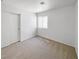 A bright bedroom features neutral carpet, a window, and closet for a serene and organized living space at 2125 Stone Well Rd, North Las Vegas, NV 89031