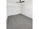 This spacious bedroom includes carpet flooring, a ceiling fan, and white walls at 2125 Stone Well Rd, North Las Vegas, NV 89031