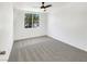 Bedroom has a ceiling fan, carpet flooring, and a window bringing in natural light at 2125 Stone Well Rd, North Las Vegas, NV 89031