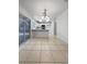 Bright kitchen features tile floors, white cabinets, a breakfast bar, and modern lighting at 2125 Stone Well Rd, North Las Vegas, NV 89031