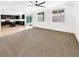 Open-concept living space with a carpeted living room, tile flooring, and a modern kitchen at 2125 Stone Well Rd, North Las Vegas, NV 89031