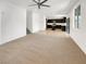 Spacious living room flows into kitchen with dark cabinets and tile flooring at 2125 Stone Well Rd, North Las Vegas, NV 89031