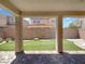 Covered patio provides shade for the outdoor turf area with brick pavers at 2125 Stone Well Rd, North Las Vegas, NV 89031