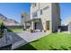 Well-maintained backyard featuring a covered patio, artificial turf, and desert landscaping at 2151 Noble Perch St, Las Vegas, NV 89138