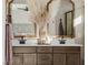 A luxurious bathroom featuring a double vanity with decor, and a seamless view of the bedroom interior at 2151 Noble Perch St, Las Vegas, NV 89138