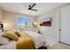 Bedroom featuring a large window, ceiling fan, and comfortable seating at 2151 Noble Perch St, Las Vegas, NV 89138
