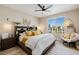 Bright bedroom featuring a large window, ceiling fan, and stylish furniture at 2151 Noble Perch St, Las Vegas, NV 89138