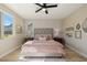 A sunlit bedroom presents a tranquil retreat, with ample natural light and views from the large window at 2151 Noble Perch St, Las Vegas, NV 89138