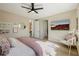 An airy bedroom showcasing a comfortable seating area, stylish TV, and convenient access to other parts of the home at 2151 Noble Perch St, Las Vegas, NV 89138