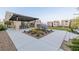 Community outdoor patio area with a pergola, picnic table, and desert landscaping at 2151 Noble Perch St, Las Vegas, NV 89138