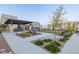 Community outdoor patio area with a pergola, picnic table, and desert landscaping at 2151 Noble Perch St, Las Vegas, NV 89138