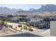 Beautiful view of the community entrance with well-manicured landscaping and mountain backdrop at 2151 Noble Perch St, Las Vegas, NV 89138