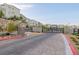 View of the gated community entrance with modern homes and well-maintained landscaping at 2151 Noble Perch St, Las Vegas, NV 89138