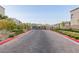 View of the gated community entrance with modern homes and well-maintained landscaping at 2151 Noble Perch St, Las Vegas, NV 89138