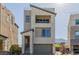 Modern two-story home featuring a balcony, neutral stucco, and desert landscaping at 2151 Noble Perch St, Las Vegas, NV 89138