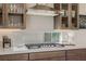 Gas cooktop with stainless steel vent hood and bright countertops in a modern kitchen at 2151 Noble Perch St, Las Vegas, NV 89138