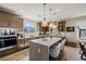 Modern kitchen featuring stainless steel appliances, island with seating and stunning pendant lights at 2151 Noble Perch St, Las Vegas, NV 89138