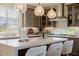 Bright kitchen featuring white countertops, island with seating and mountain views at 2151 Noble Perch St, Las Vegas, NV 89138