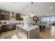 Modern kitchen with stainless steel appliances, island and open layout with living area at 2151 Noble Perch St, Las Vegas, NV 89138