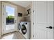 Bright laundry room with modern washer and dryer and access to the backyard at 2151 Noble Perch St, Las Vegas, NV 89138