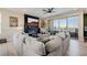 Open living room with a comfortable sectional sofa, fireplace, and sliding glass doors to a balcony at 2151 Noble Perch St, Las Vegas, NV 89138