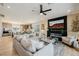 Open living space featuring a fireplace, balcony access, and seamless flow to the kitchen and dining area at 2151 Noble Perch St, Las Vegas, NV 89138