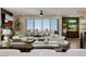 An open living room with modern furnishings and a sliding glass door to a balcony with a view at 2151 Noble Perch St, Las Vegas, NV 89138