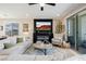 Living room with fireplace, balcony access, and comfortable seating at 2151 Noble Perch St, Las Vegas, NV 89138