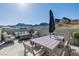 Rooftop deck with dining table, fire pit, and comfortable seating with mountain views at 2151 Noble Perch St, Las Vegas, NV 89138