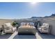 Relaxing rooftop patio featuring a modern fire pit, cozy seating, and picturesque mountain scenery at 2151 Noble Perch St, Las Vegas, NV 89138