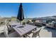 Inviting rooftop patio featuring comfortable seating, a dining table, and stunning mountain views at 2151 Noble Perch St, Las Vegas, NV 89138