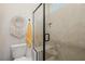 Modern walk-in shower featuring glass doors, tile surround, and bench seating at 2151 Noble Perch St, Las Vegas, NV 89138