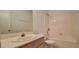 Bright bathroom featuring a single sink, shower-tub combo with white tile surround at 2216 Short Pine Dr, Las Vegas, NV 89108