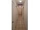 Long hallway featuring tile flooring and white doors to bedrooms at 2216 Short Pine Dr, Las Vegas, NV 89108