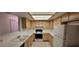 Clean kitchen featuring light cabinets, white countertops and appliances, and tile flooring at 2216 Short Pine Dr, Las Vegas, NV 89108