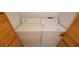 Convenient laundry area with washer, dryer, and wood slat doors at 2216 Short Pine Dr, Las Vegas, NV 89108