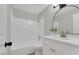 Bathroom with bathtub, white vanity, modern lighting, and elegant framed mirror at 2480 Old Forge Ln # 74, Las Vegas, NV 89121