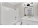Bathroom featuring bathtub, white vanity, modern lighting, and elegant framed mirror at 2480 Old Forge Ln # 74, Las Vegas, NV 89121