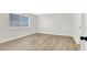 Light and airy bedroom with wood look flooring, large window, and neutral paint at 2480 Old Forge Ln # 74, Las Vegas, NV 89121
