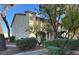 Charming multi-story home with lush landscaping and a welcoming walkway at 2480 Old Forge Ln # 74, Las Vegas, NV 89121