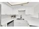 Modern kitchen features white cabinetry, stainless steel appliances, and granite countertops at 2480 Old Forge Ln # 74, Las Vegas, NV 89121