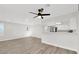 Living room featuring wood floors, white walls and trim, and open kitchen access at 2480 Old Forge Ln # 74, Las Vegas, NV 89121